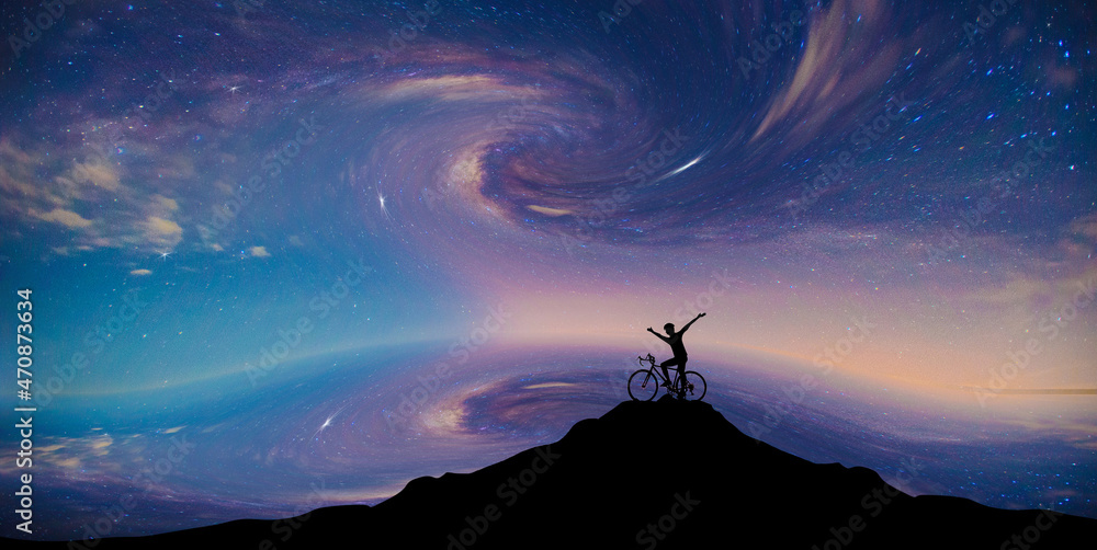 The Milky Way at the End of the World Blur shadow.Silhouette biker on top of a mountain.