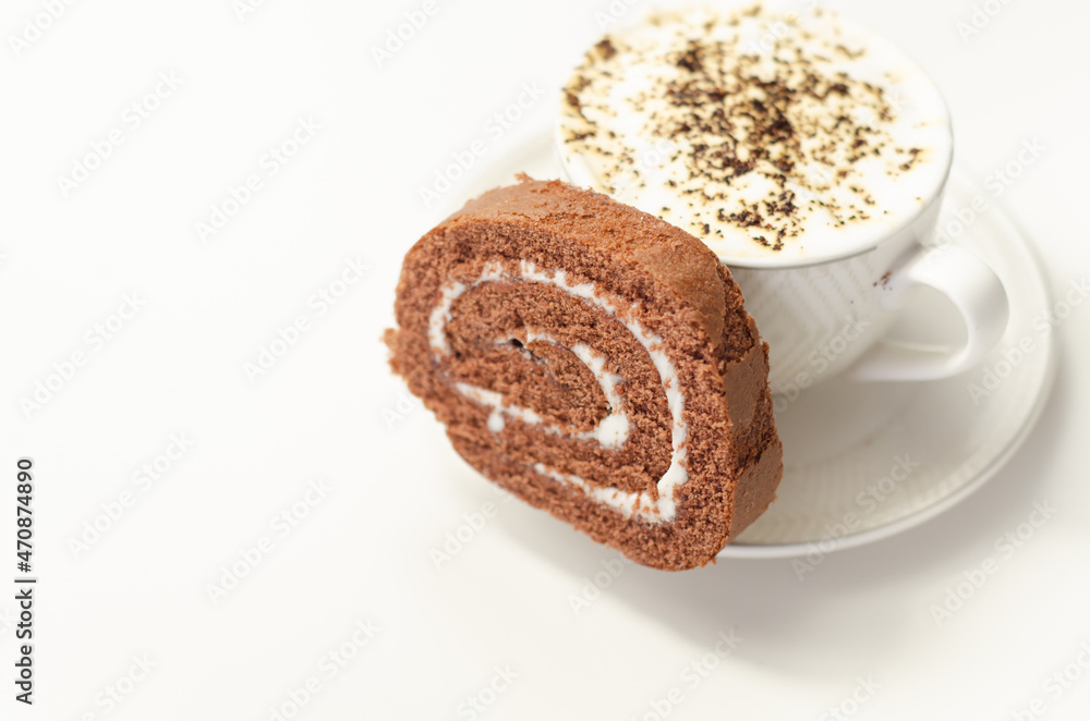 Chocolate sponge roll with a vanilla flavour filling and fresh coffee in the cup, chocolate swiss roll Chocolate sponge roll with a vanilla flavour filling and fresh coffee in the cup, chocolate swiss roll