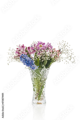 Bouquet of flowers in crystal vase on white background