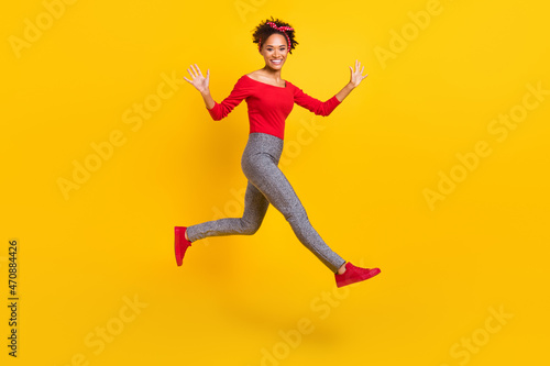 Photo of cheerful excited lady jump run hurry rush wear pin-up outfit headband isolated yellow color background