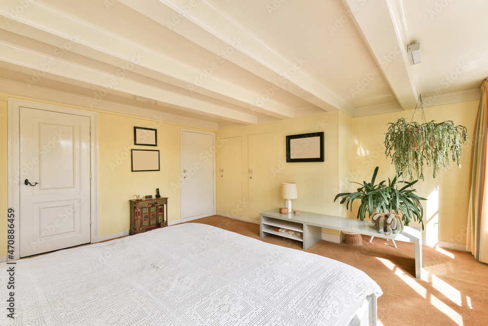 Spacious bedroom with bed and doors Spacious bedroom with bed and doors