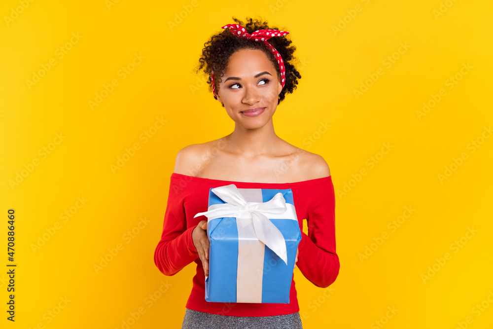 Photo of dreamy inspired lady hold gift look empty space wear pin-up outfit isolated yellow color background Photo of dreamy inspired lady hold gift look empty space wear pin-up outfit isolated yellow color background