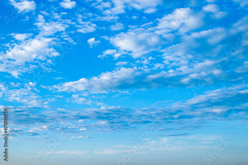 White clouds in sunny weather against blue sky.