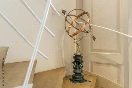 Armillary sphere on stairs in apartment photo