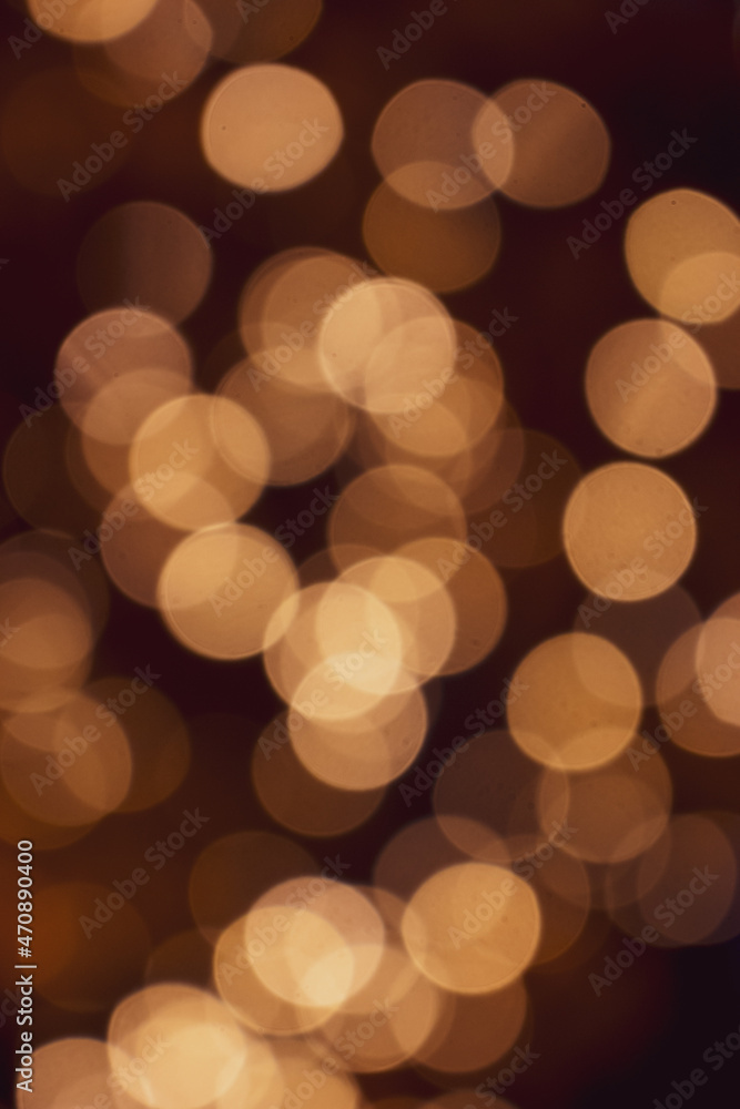 Golden Christmas lights on dark background, unfocused. Illuminated bokeh background. Glowing lights defocused. Winter holidays magic. Golden stardust lights. Christmas decoration. Festive illumination Golden Christmas lights on dark background, unfocused. Illuminated bokeh background. Glowing lights defocused. Winter holidays magic. Golden stardust lights. Christmas decoration. Festive illumination