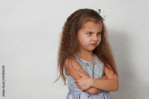 Portrait of 5 years old girl wearing grey dress photo