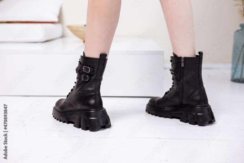 Black winter women's boots made of genuine leather with laces close-up. High quality stylish women's shoes Black winter women's boots made of genuine leather with laces close-up. High quality stylish women's shoes