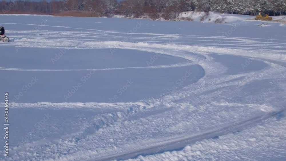 Aerial view snow motocross racing. Motocross rider on bike, motocross winter season race. Aerial view snow motocross racing. Motocross rider on bike, motocross winter season race.
