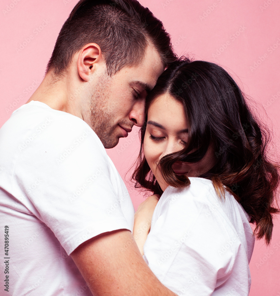 young cheerful caucasian couple together having fun on pink background, guy ang girl modern relationship, lifestyle people concept young cheerful caucasian couple together having fun on pink background, guy ang girl modern relationship, lifestyle people concept