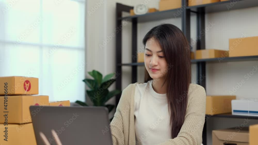 Young asian entrepreneur woman checking product on stock take note with laptop. Business woman working SME online at home. Check address on parcel. Small business owner start up freelance concept. Young asian entrepreneur woman checking product on stock take note with laptop. Business woman working SME online at home. Check address on parcel. Small business owner start up freelance concept.
