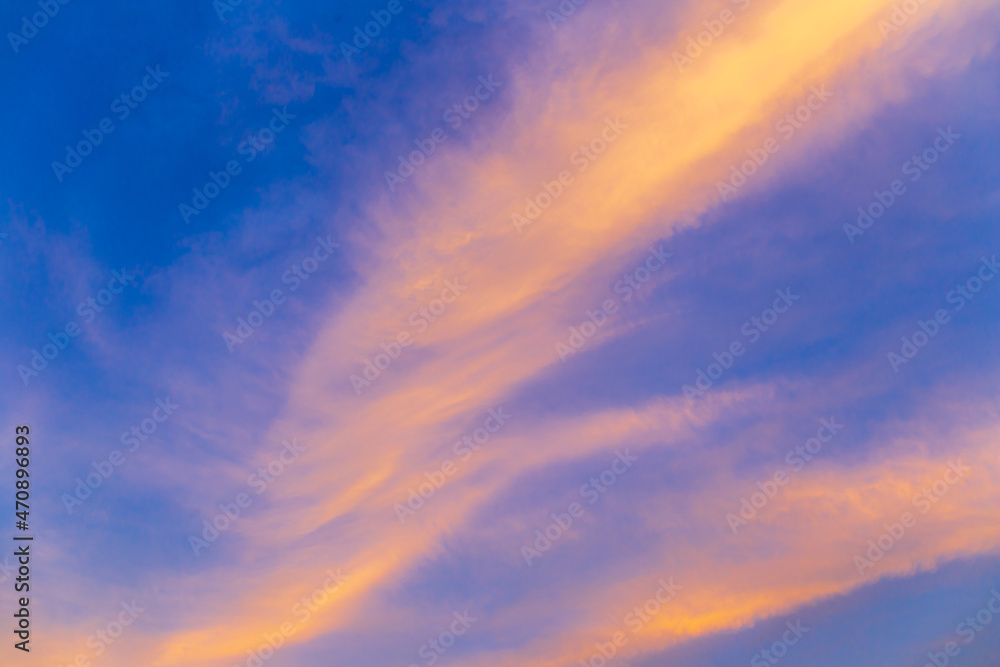 Abstract nature background. Dramatic blue sky with orange colorful sunset clouds in twilight time