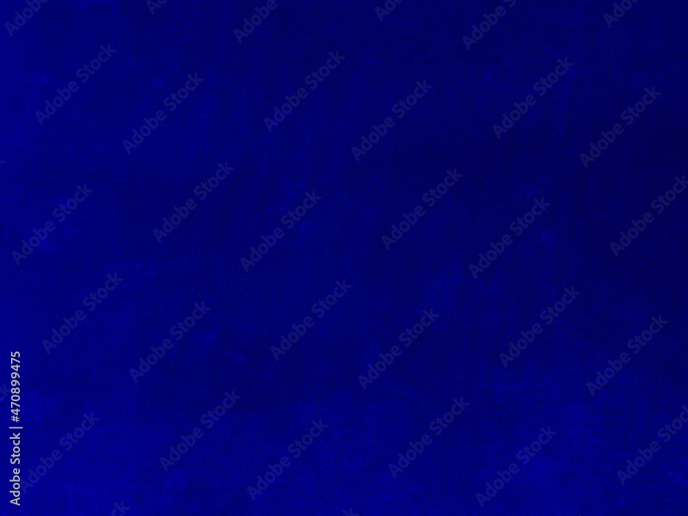 Dark blue velvet fabric texture used as background. Empty blue fabric background of soft and smooth textile material. There is space for text..
