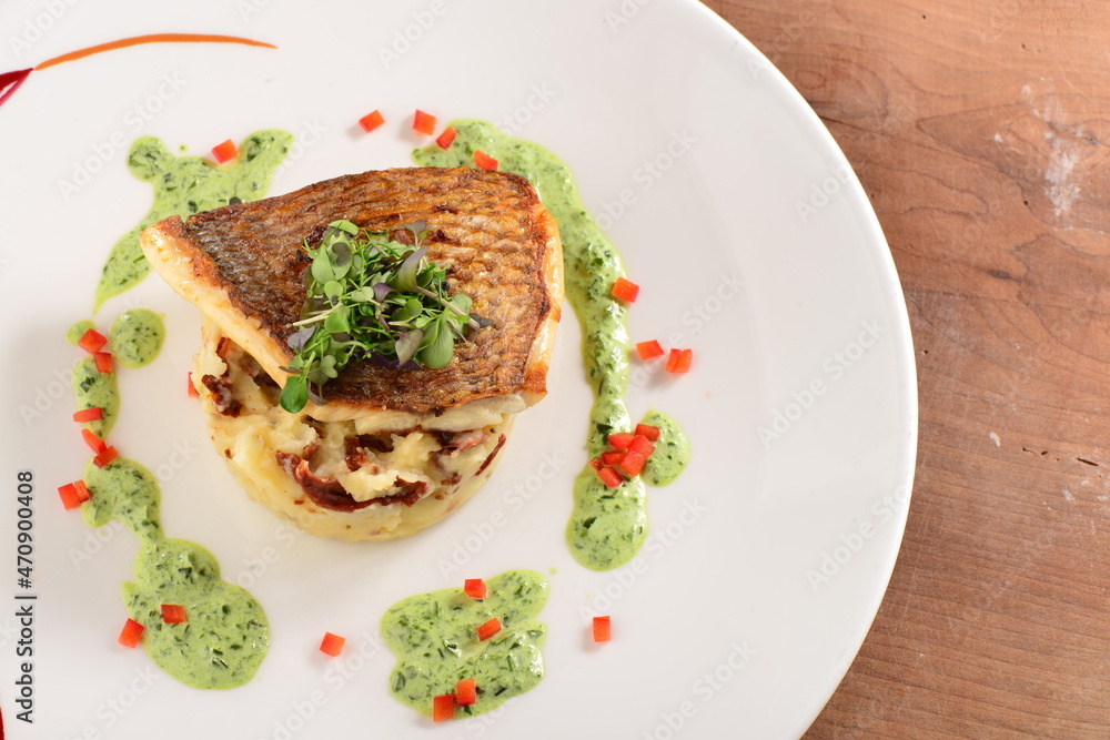 Tasty healthy fish fillet with potato puree with dried tomatoes and wild garlic sauce Tasty healthy fish fillet with potato puree with dried tomatoes and wild garlic sauce