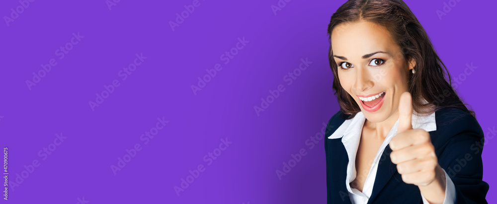 Businesswoman in confident black suit, showing thumbs up hand gesture, copy space for text, isolated over violet purple color background. Business concept photo. Businesswoman in confident black suit, showing thumbs up hand gesture, copy space for text, isolated over violet purple color background. Business concept photo.