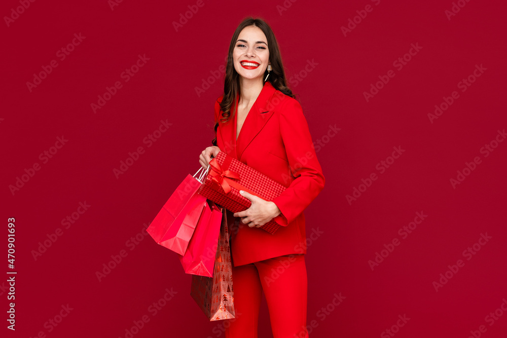 attractive woman in red with shopping bags sale on red background attractive woman in red with shopping bags sale on red background