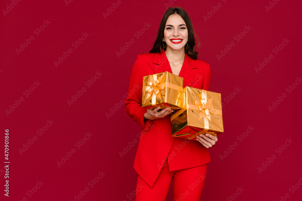 attractive woman celebrating Christmas on red background attractive woman celebrating Christmas on red background