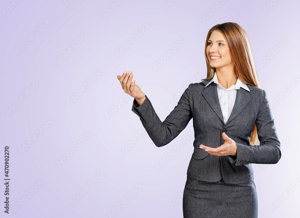 Woman showing pointing on background. Young lady smiling happy presenting Woman showing pointing on background. Young lady smiling happy presenting