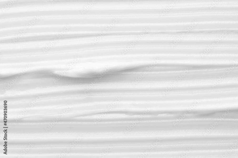 Texture of smooth white creamy cosmetic product smears as background with space for design extreme close view from above