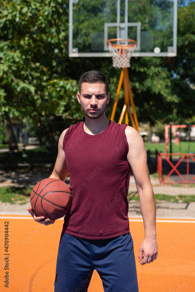 Portrait of young basketball player on a streest court. Portrait of young basketball player on a streest court.