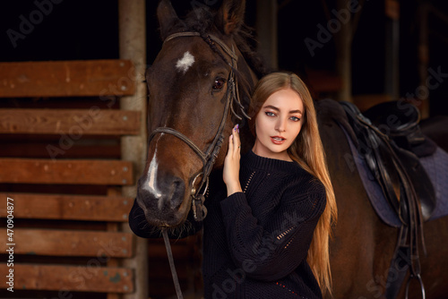 beautiful caucasian girl with a horse in the forest at sunset
