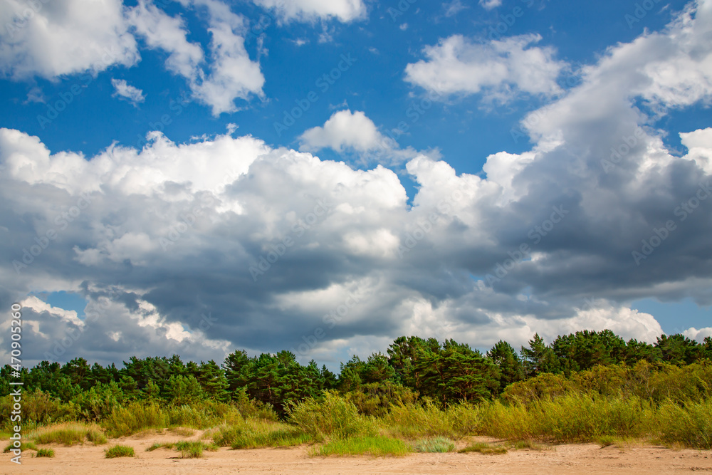 Panorama of the warm Gulf of Riga of the Baltic Sea against the background of cumulus clouds. The coast of the Gulf of Riga in Latvia is popular with tourists. Panorama of the warm Gulf of Riga of the Baltic Sea against the background of cumulus clouds. The coast of the Gulf of Riga in Latvia is popular with tourists.