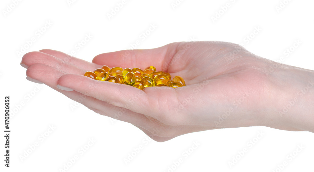 Vitamin D pills in hand on white background isolation Vitamin D pills in hand on white background isolation