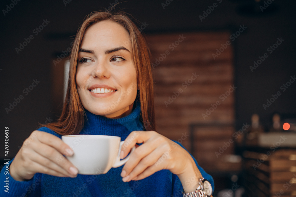 Potrait of woman holding a cup of coffee Potrait of woman holding a cup of coffee
