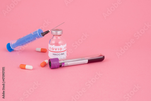 Various colored drugs, syringe and needle, vaccination against coronavirus (COVID-19)