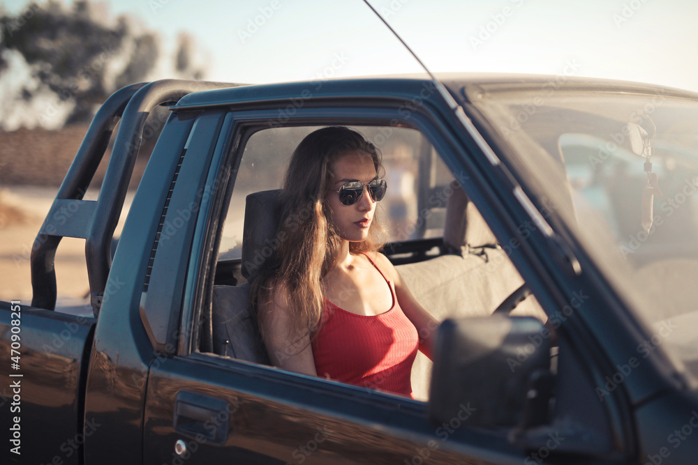 young woman behind the wheel of an off-road vehicle