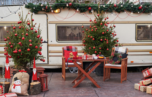 Christmas tree background. Van mobile trailer  mobile home  terrace. New Year celebration. Winter holidays. Christmas morning. Camper van in camp ground  caravan van.