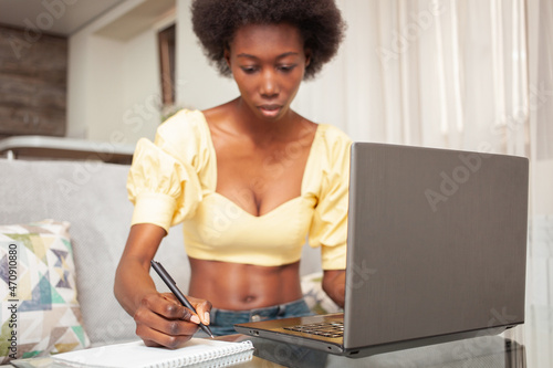 portrait of African American black woman  freelancer  working from home. laptop