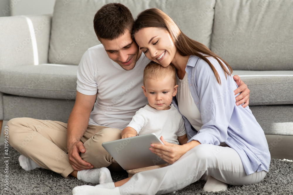 Happy Parents And Their Toddler Baby Playing With Digital Tablet At Home Happy Parents And Their Toddler Baby Playing With Digital Tablet At Home