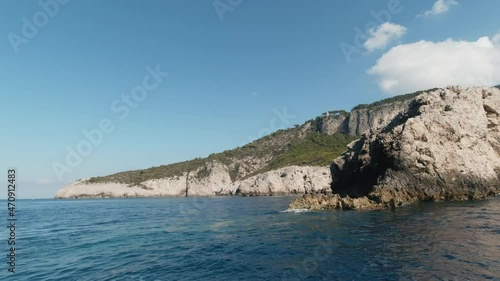 Capri Island cliff sea shores, ighthouse, view from speed boat, editorial image photo