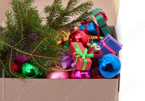 Christmas toys with a Christmas tree branch in a box.