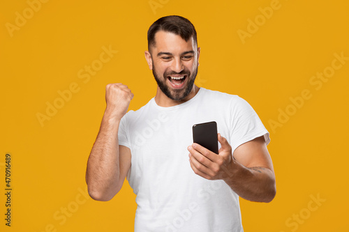 Satisfied happy adult european man feeling euphoric, enjoying good message and online victory