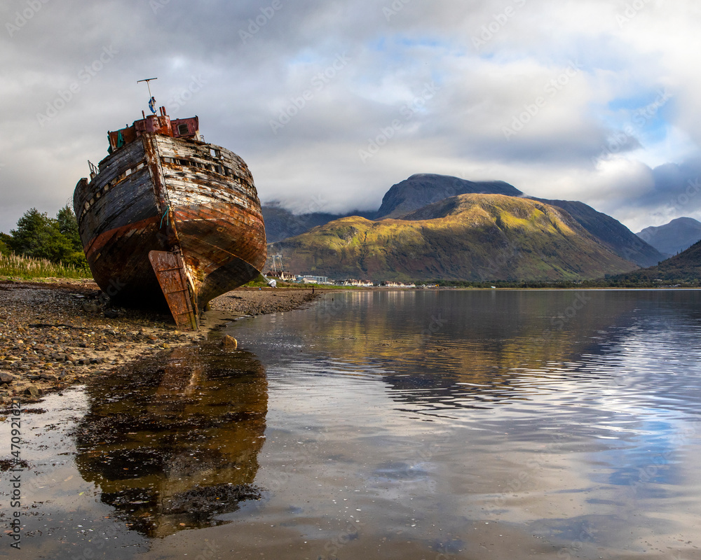 Old Boat of Caol and Ben Nevis in Scotland, UK.