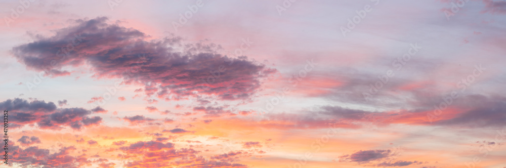 Panoramic clouds in high resolution in pastel tones at sunset or sunrise. Banner in large size. Concept of happiness religion or climate change.