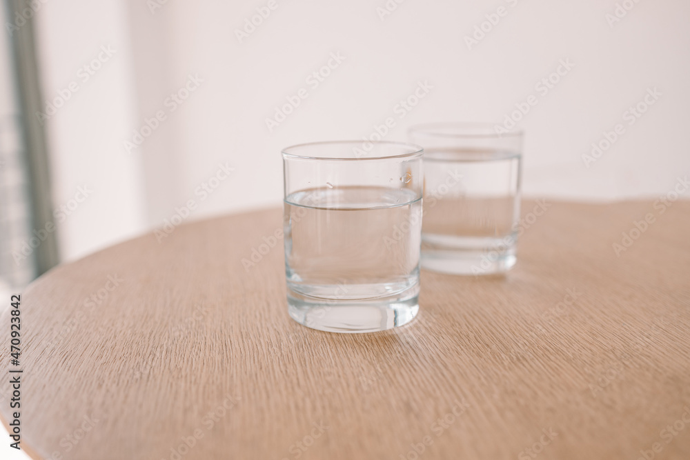 Glass of water on wooden table at modern style cafe. Tasty morning drinks. Glass of water on wooden table at modern style cafe. Tasty morning drinks.