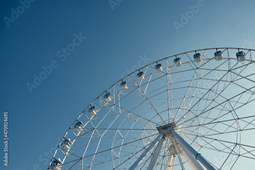 Low angle view of ferris wheel against blue sky