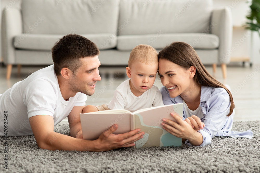 Early Education For Kids. Parents Reading Book To Their Cute Toddler Son Early Education For Kids. Parents Reading Book To Their Cute Toddler Son