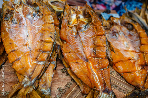 Dried and smoked  fish at the fish market. Salmon and silver carp. Market 