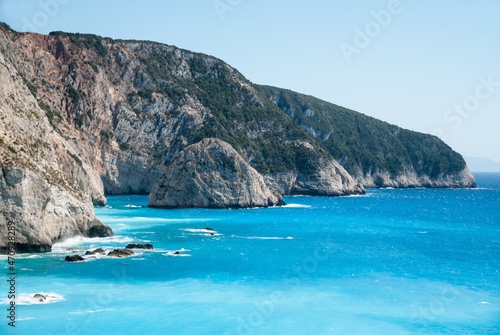 Cliffs over clear blue sea