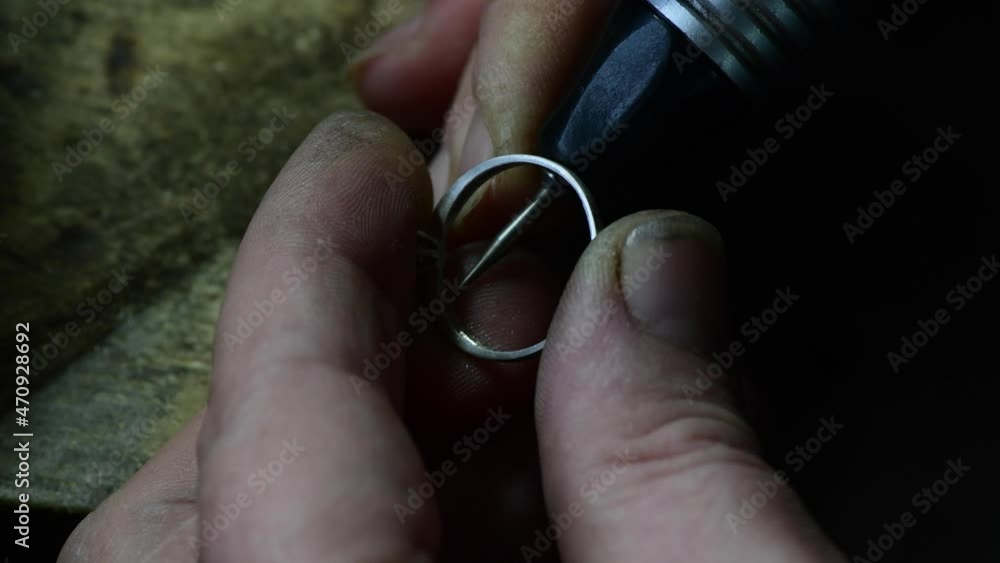 Closeup of wedding ring polishing by caicasian jeweler isolated, 4k footage