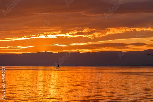 Sailboat on Lake Geneva at the golden hour of sunset. © fotosdanielgbueno