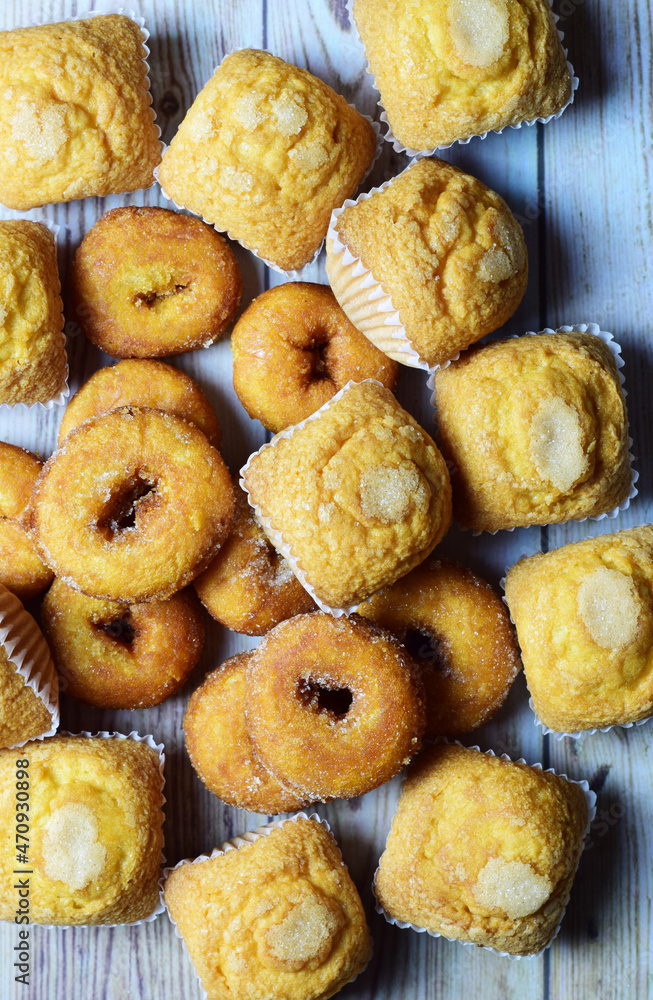 Vertical shot, sugared muffins and doughnuts, sweet background. Vertical shot, sugared muffins and doughnuts, sweet background.