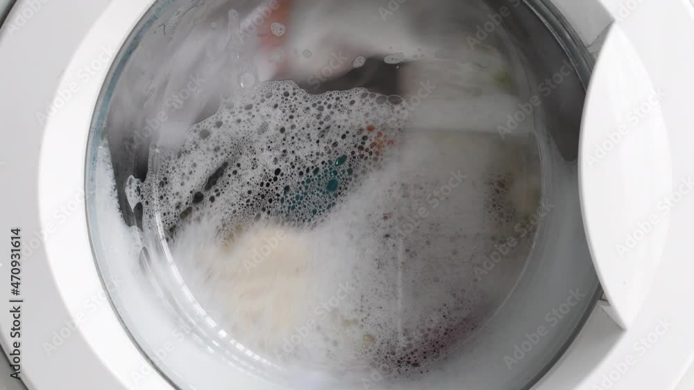 video of a washing machine washing clothes with soap, spinning and rinsing the laundry. concept energy and rise of electric light video of a washing machine washing clothes with soap, spinning and rinsing the laundry. concept energy and rise of electric light