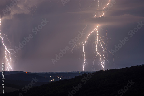 Huge lightnings at night with landscape