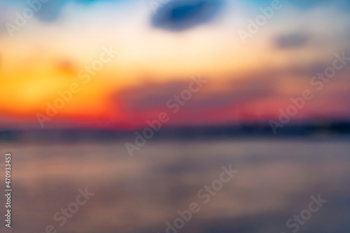 sunset over the river in city of saint-petersburg. Blurred background of clouded sky and water