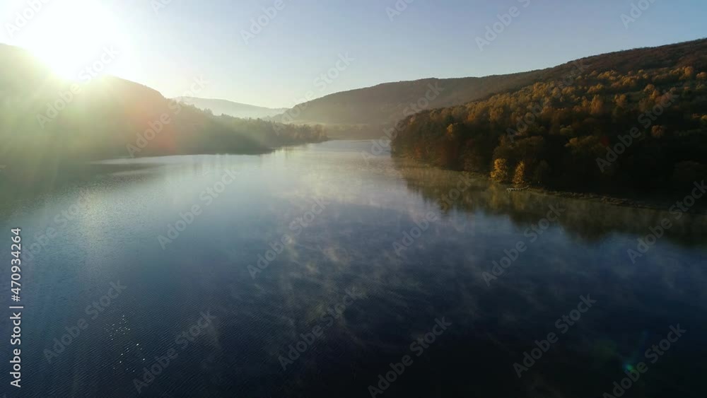 Aerial view of lake and mountains at fall. Aerial view of beautiful colorful fall landscape. Autumn in mountains, epic aerial vista.