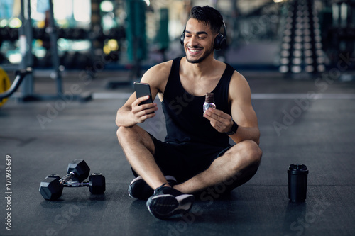 Snack Break. Smiling Young Arab Man Resting At Gym After Training